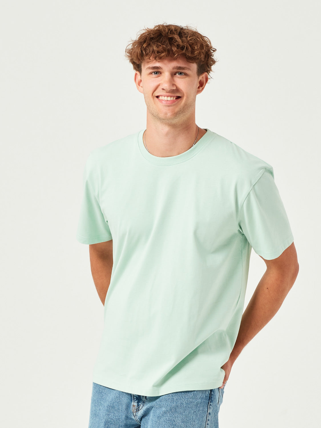 Mann trägt ein mint grünes BoxFit T-Shirt aus 100% Bio-Baumwolle – nachhaltige Herrenmode, lässiger Oversize-Schnitt, umweltfreundlich & bequem