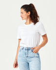 Weißes Damen T-Shirt aus hochwertiger Bio-Baumwolle, in der Hose gesteckt getragen von Frau mit hellblauer Jeans. Komfortables Rundhals-Shirt mit kurzen Ärmeln. Perfektes Basic für moderne Casual Styles und nachhaltige Damenmode.